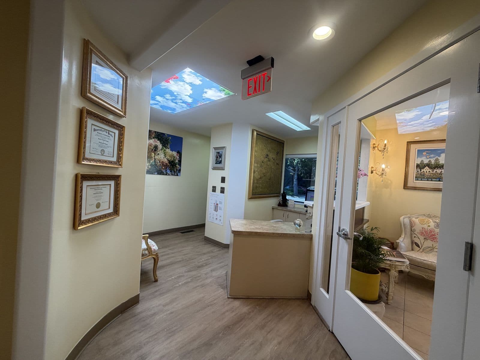 Hallway with framed certificates leading to reception